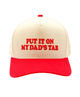 Beige and red cap with text 'PUT IT ON MY DAD'S TAB' on a white background