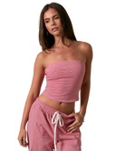 Woman wearing a RED AND WHITE STRIPED strapless top and pants on a white background