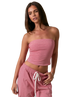 Woman wearing a RED AND WHITE STRIPED strapless top and pants on a white background
