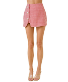 Red and white checkered skirt worn by a person on a white background