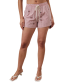 Person wearing red striped shorts with American flags on a white background