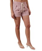Person wearing red striped shorts with American flags on a white background