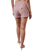 Person wearing red striped shorts with American flags on a white background