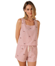 Woman wearing a red stripe sleeveless top and shorts with small USA flag patterns on a white background