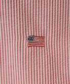 Red and white striped fabric with an embroidered American flag patch.