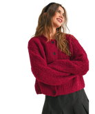 Woman wearing a red cardigan on a white background