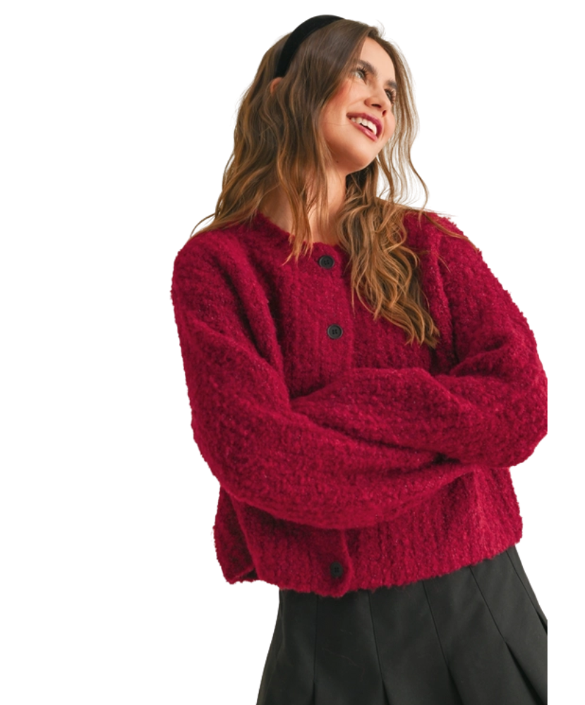 Woman wearing a red cardigan on a white background