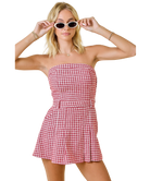 Woman wearing a red and white checkered dress on a white background