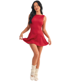 Woman wearing a red polka dot dress on a white background