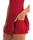 Red polka dot dress with a pocket on a white background