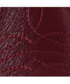 Close-up of a textured red fabric with visible stitching