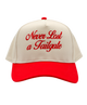 Beige and red cap with 'Never Last a Tailgate' text on a white background