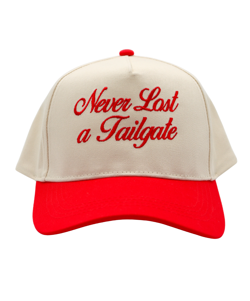 Beige and red cap with 'Never Last a Tailgate' text on a white background