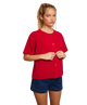 Woman wearing a red cardigan sweater and blue shorts on a white background