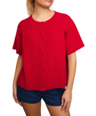 Red short-sleeve cardigan worn by a person on a white background