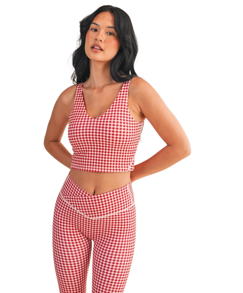 Woman wearing a red and white GINGHAM checkered tank on a white background