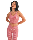 Woman wearing a red and white GINGHAM checkered tank on a white background