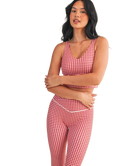 Woman wearing a red and white GINGHAM checkered tank on a white background