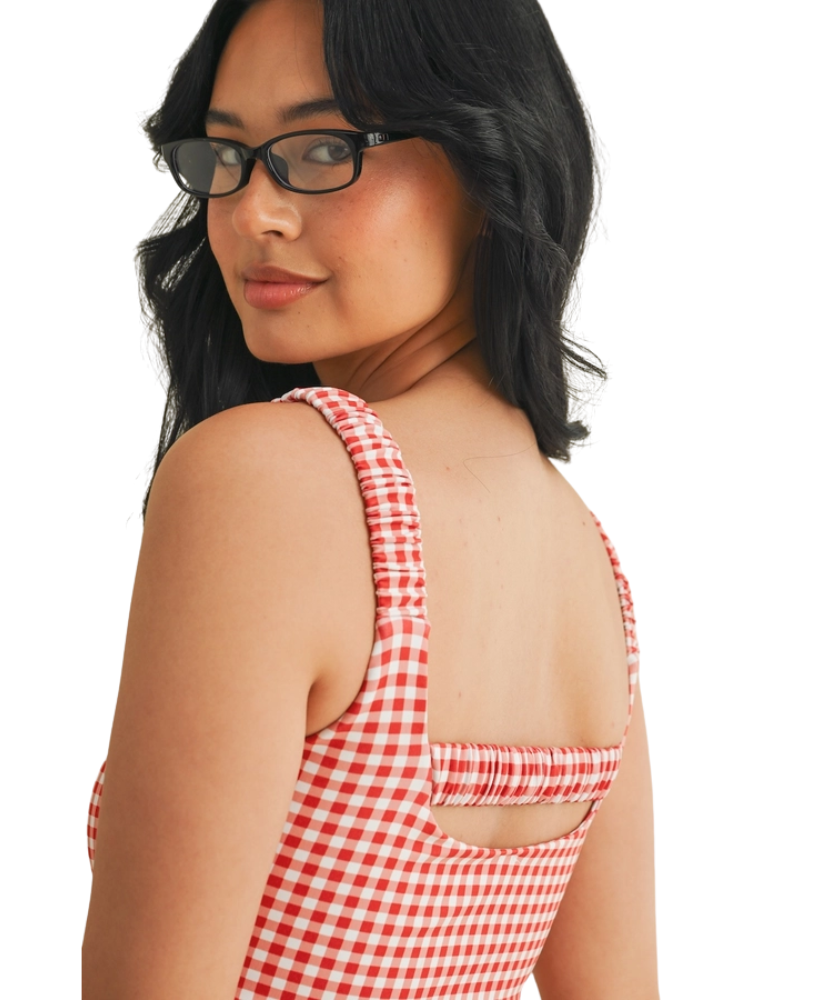Woman wearing a red and white GINGHAM checkered tsports bra on a white backgrounD