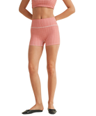 Woman wearing a red and white gingham checkered shorts on a white background