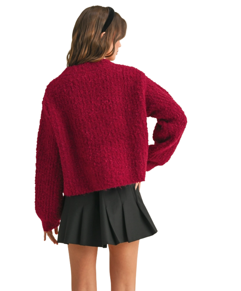 Woman wearing a red cardigan on a white background