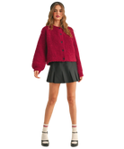 Woman wearing a red cardigan on a white background