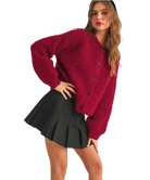 Woman wearing a red cardigan on a white background