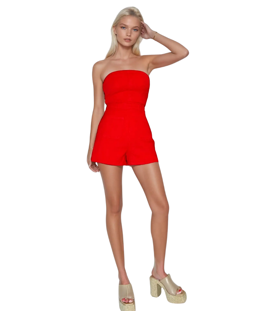 Woman wearing a red strapless romper on a white background
