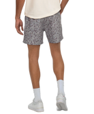 Person wearing CAMO patterned shorts on a white background