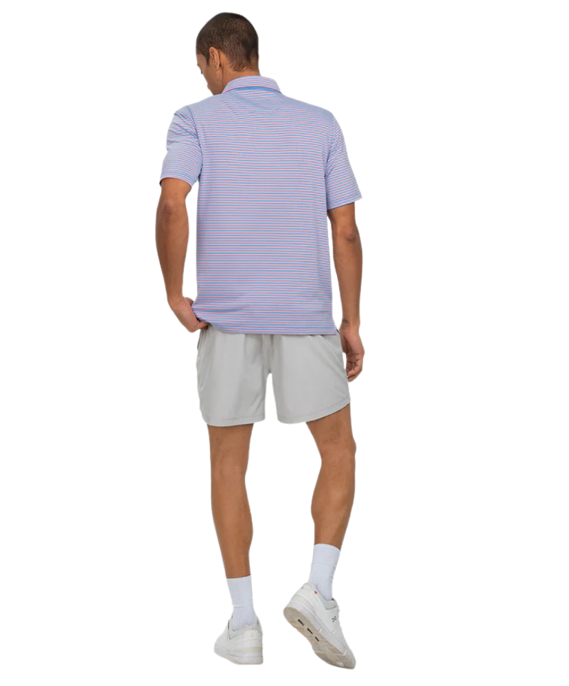 Man wearing a Southern Shirt Co light purple striped polo shirt and gray shorts on a white background