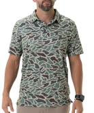 Man wearing a camouflage-patterned polo shirt on a white background