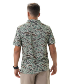 Man wearing a camouflage-patterned polo on a white background