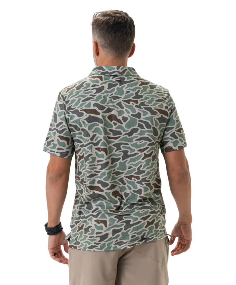 Man wearing a camouflage-patterned polo on a white background