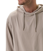 Beige hoodie worn by a person on a white background