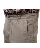 Close-up of beige pants with a patterned shirt underneath on a white background