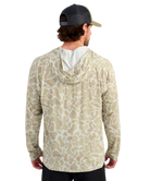 Man wearing a sand camouflage-patterned hoodie on a white background