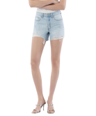 Woman wearing light blue denim shorts on a white background