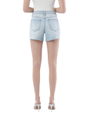Woman wearing light blue denim shorts on a white background