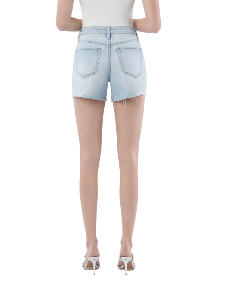 Woman wearing light blue denim shorts on a white background