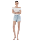 Woman wearing light blue denim shorts on a white background