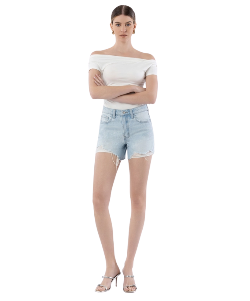 Woman wearing light blue denim shorts on a white background