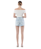 Woman wearing light blue denim shorts on a white background