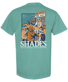 Teal t-shirt with a graphic of dogs at a bar and 'Shades' branding on a white background