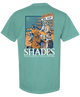 Teal t-shirt with a graphic of dogs at a bar and 'Shades' branding on a white background