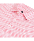 Close-up of a pink patterned shirt with a brand logo on a white background