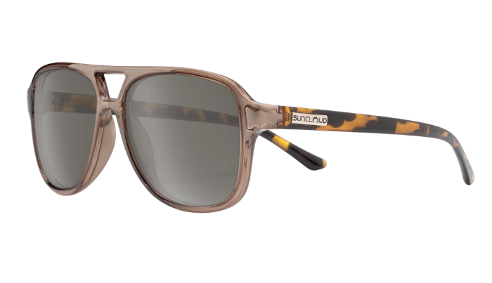 A pair of aviator-style sunglasses with a translucent taupe-brown frame, gray gradient lenses, and tortoiseshell-patterned temples. The brand name 'Buna+Nip' is visible on the temple arm.