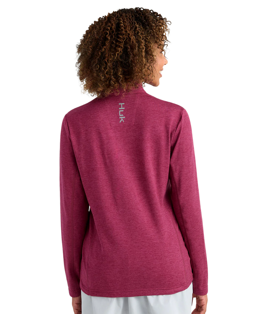 Woman wearing a maroon heather Huk pullover on a white background