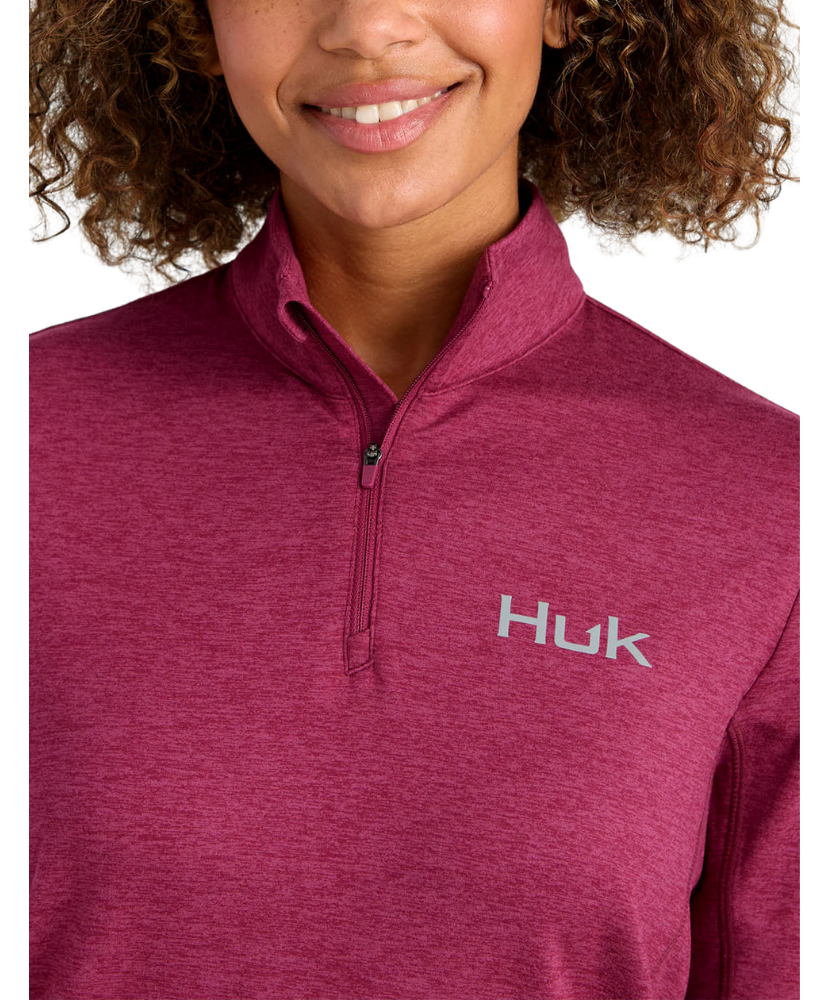 Woman wearing a maroon heather Huk pullover on a white background