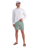 Person wearing LIGHT GREEN HUK shorts on a white background