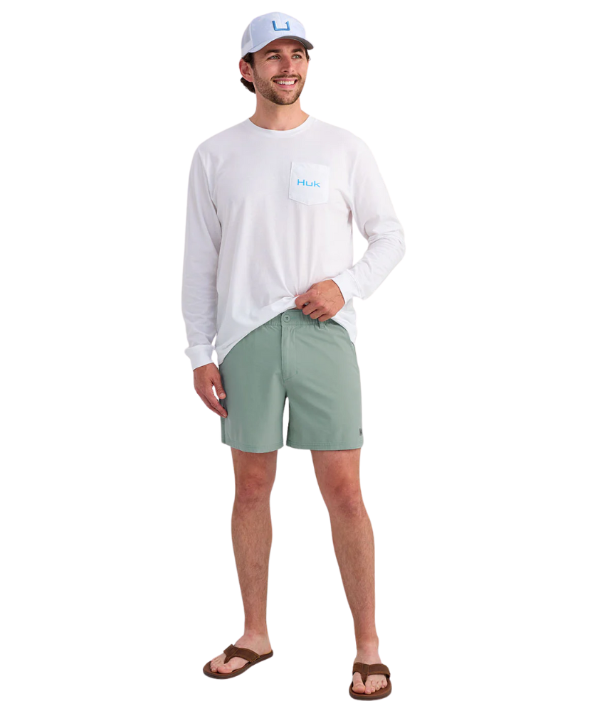 Person wearing LIGHT GREEN HUK shorts on a white background